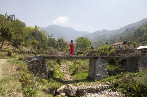 Women walking on a bridge in Nepal countryside.