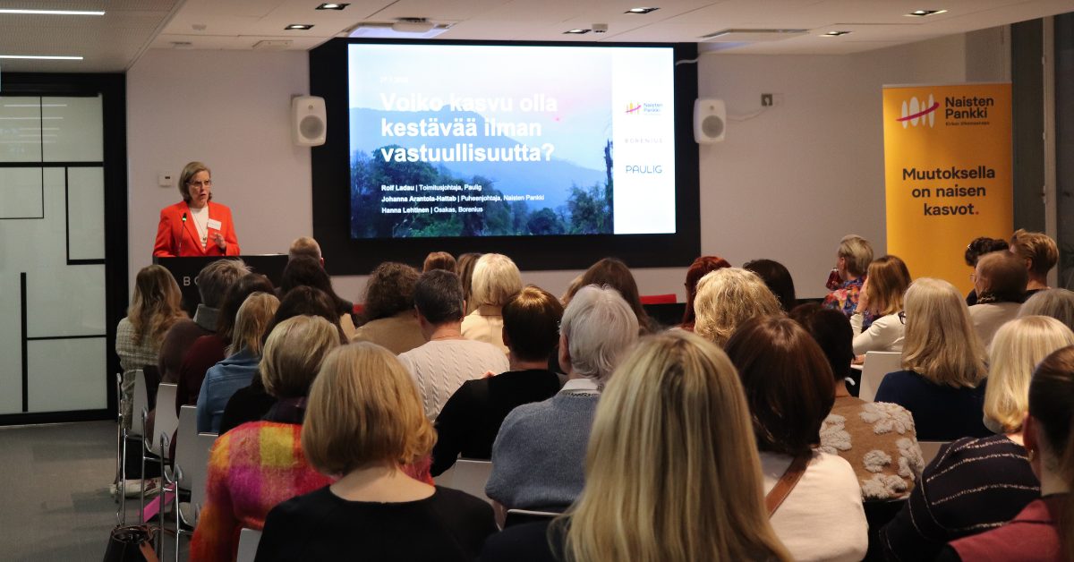 Ihmisä salissa katsomassa kuvaesitystä.